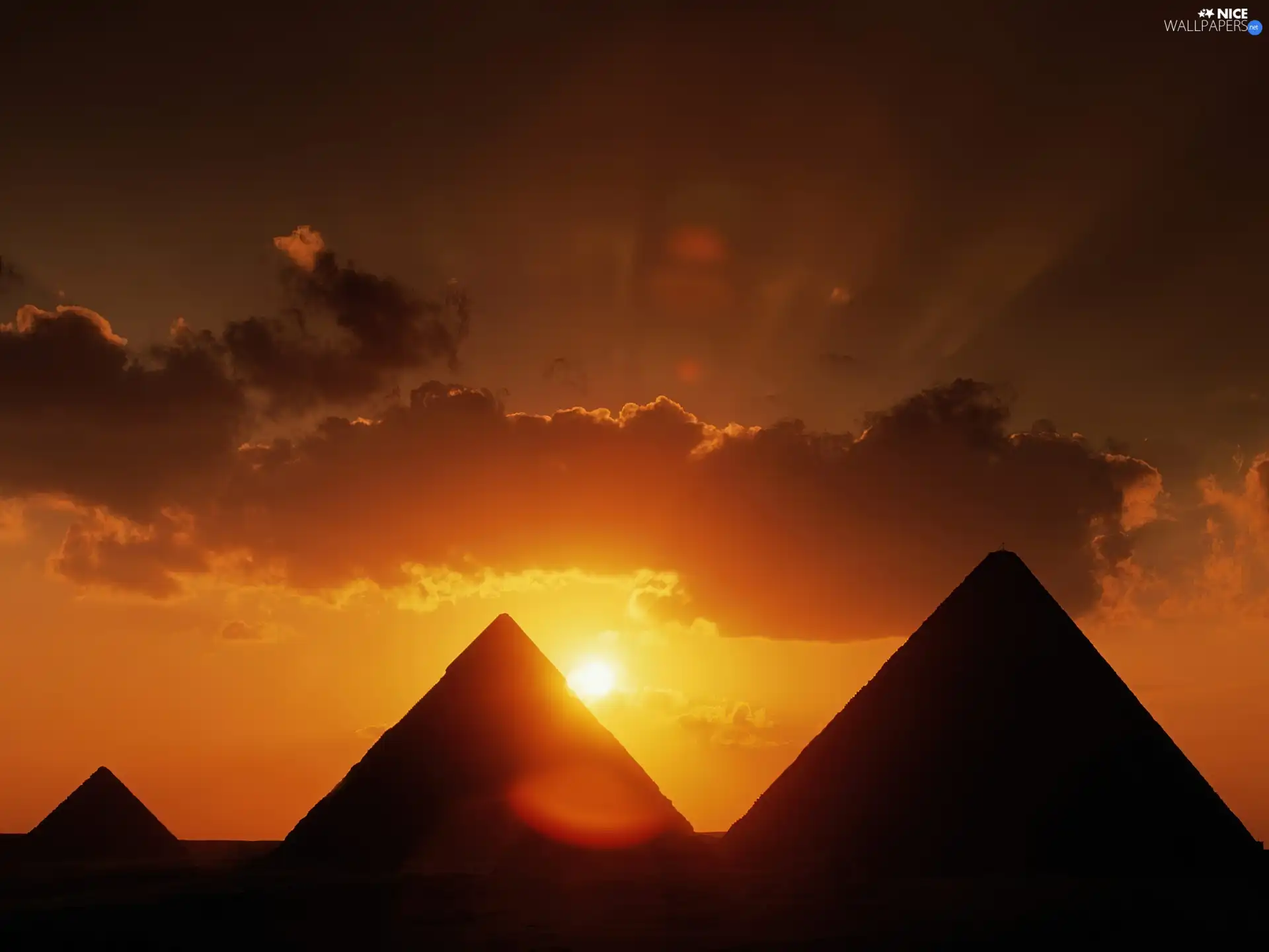 Pyramids, sun, clouds, west