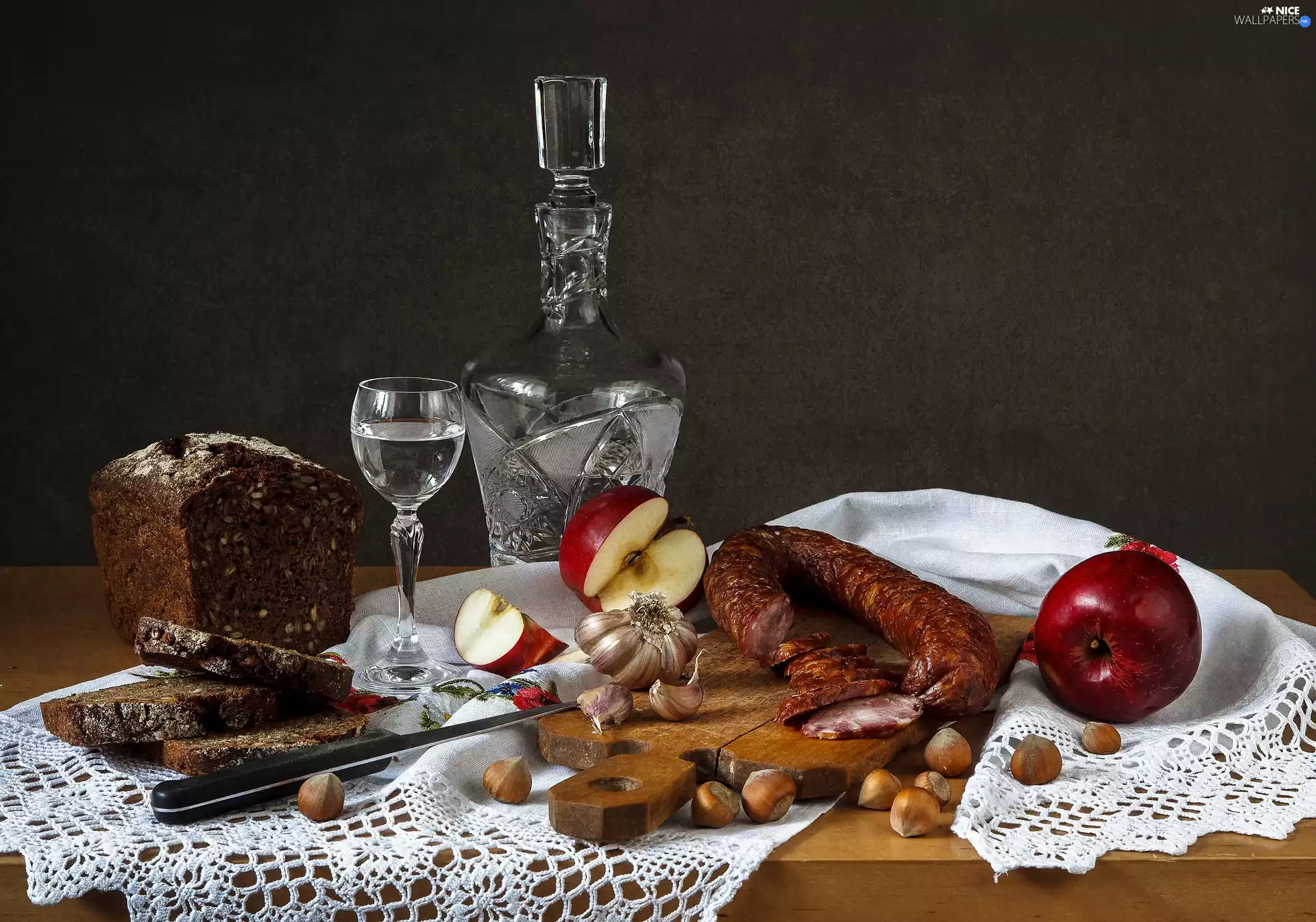 apples, bread, carafe, sausage, board, glass, nuts, composition, vodka, garlic, cloth, Table