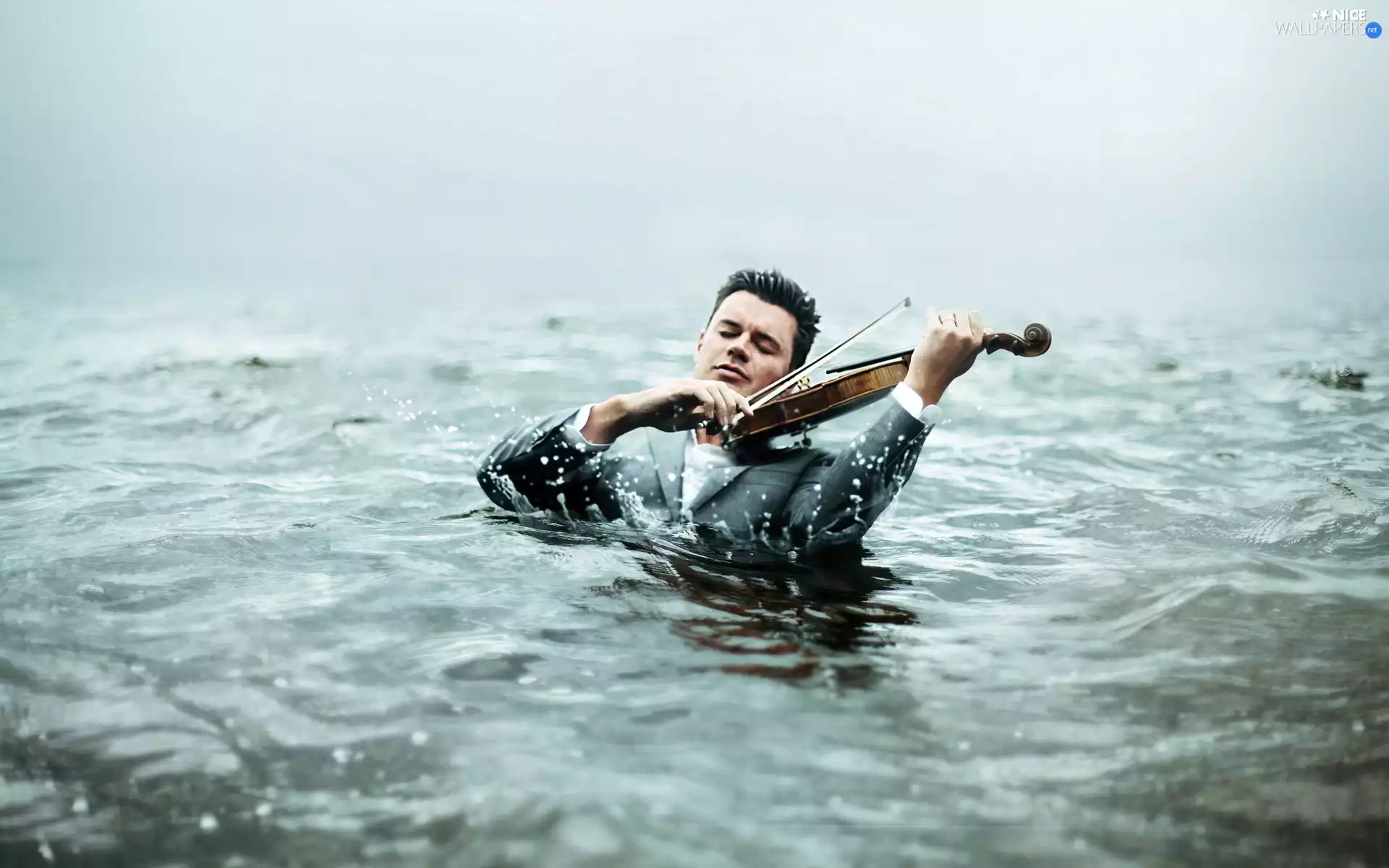 water, a man, violin