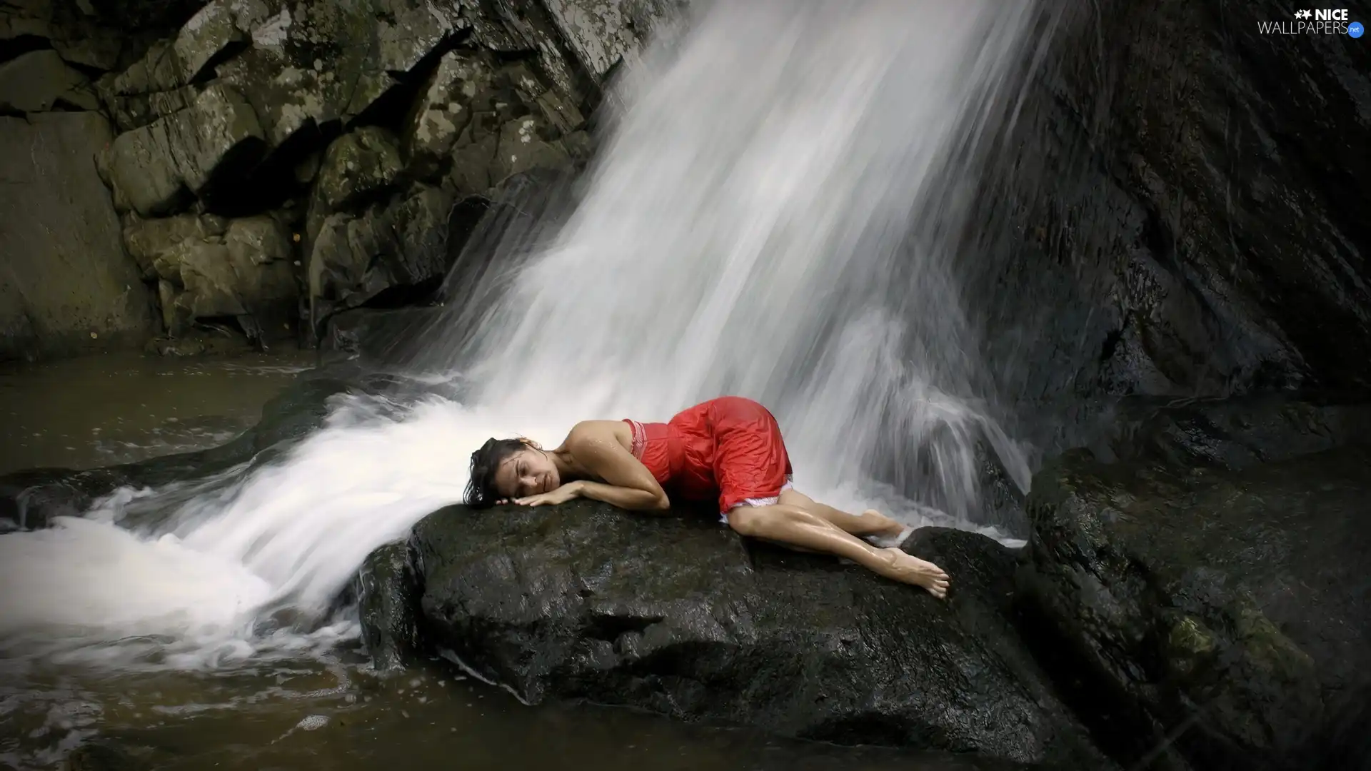 Women, rocks, waterfall