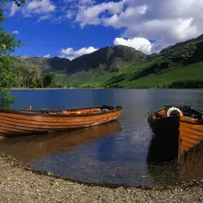 Mountains, lake, boats, clouds