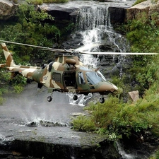 Helicopter, waterfall, rocks