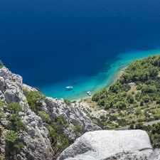 Mountains, rocks, motorboat, sea