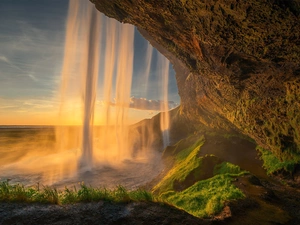 Seljalandsfoss Waterfall, rays of the Sun, rocks, illuminated, iceland